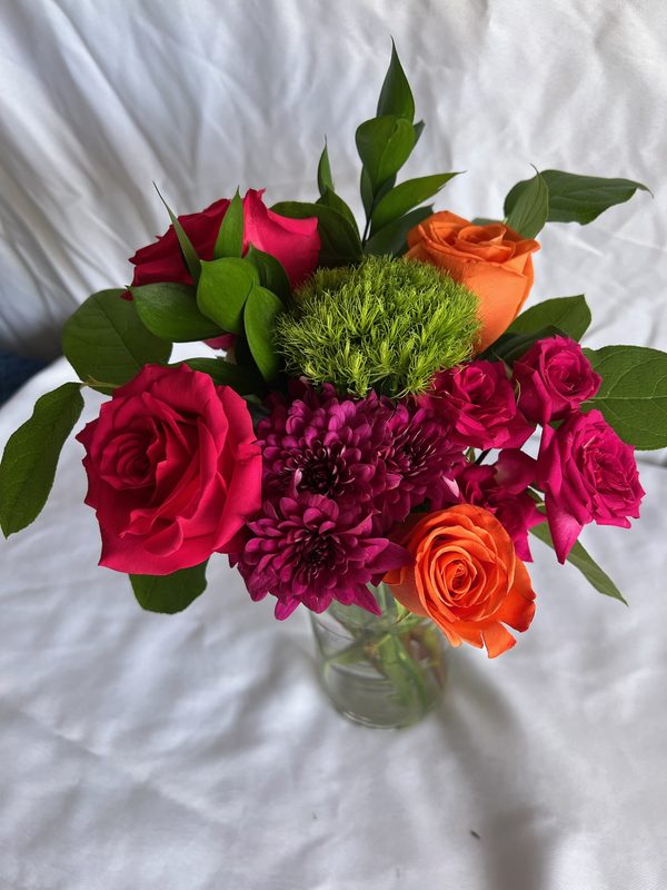 Hot pink roses, orange roses and green dianthus arrangement