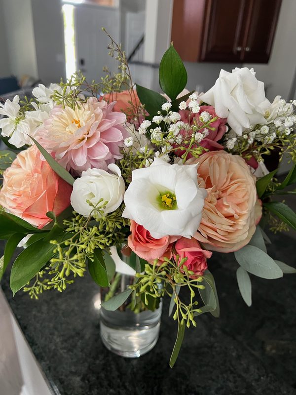 Peach, white and blush arrangement on a kitchen counter