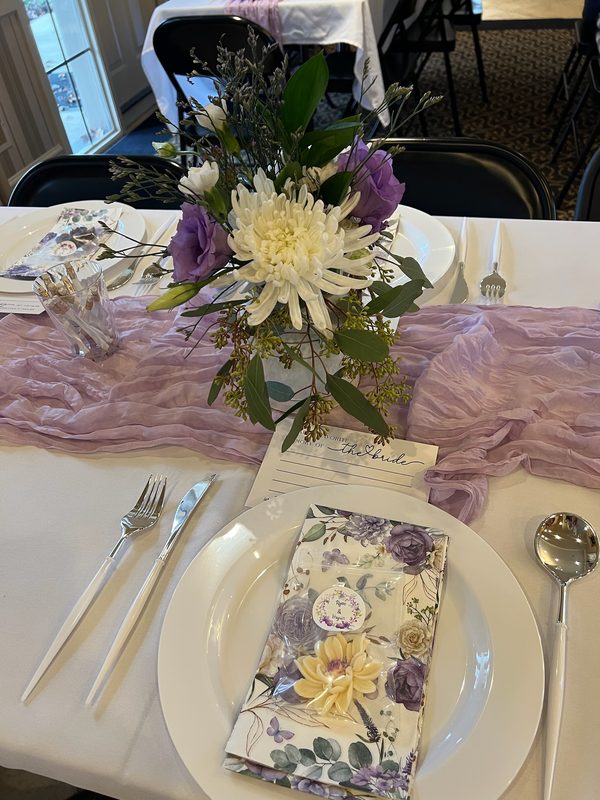 Lavender and white table setting with a floral napkin