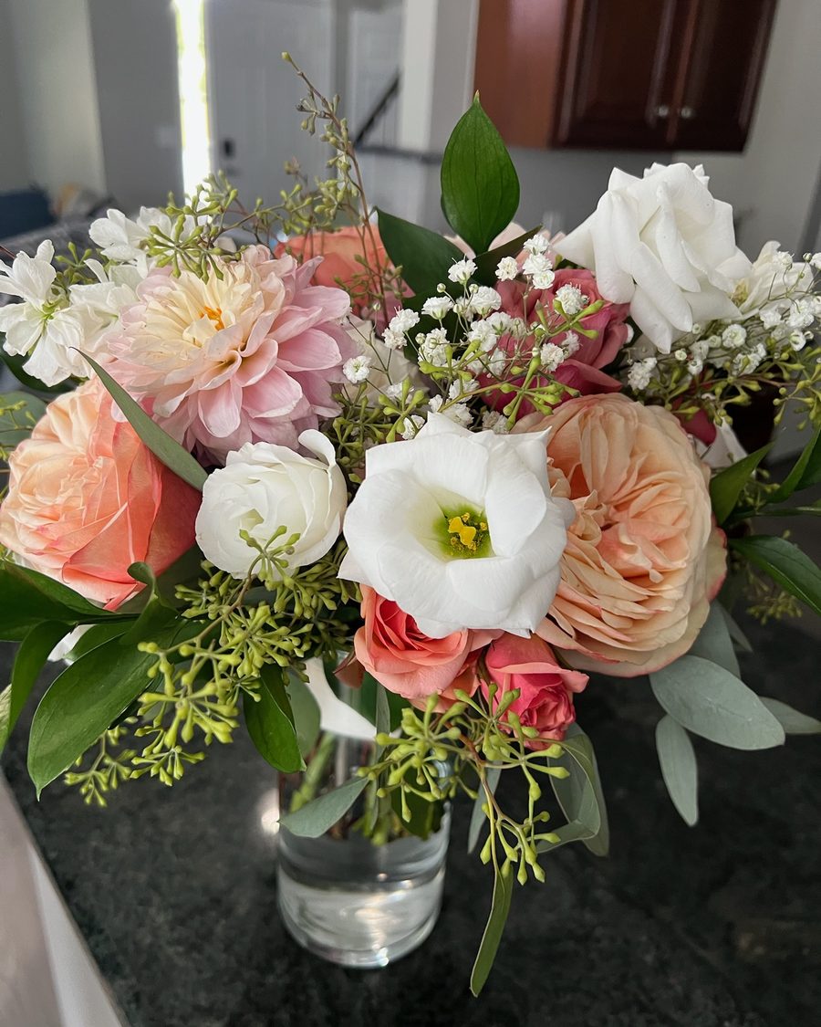Peach, white and blush arrangement on a kitchen counter